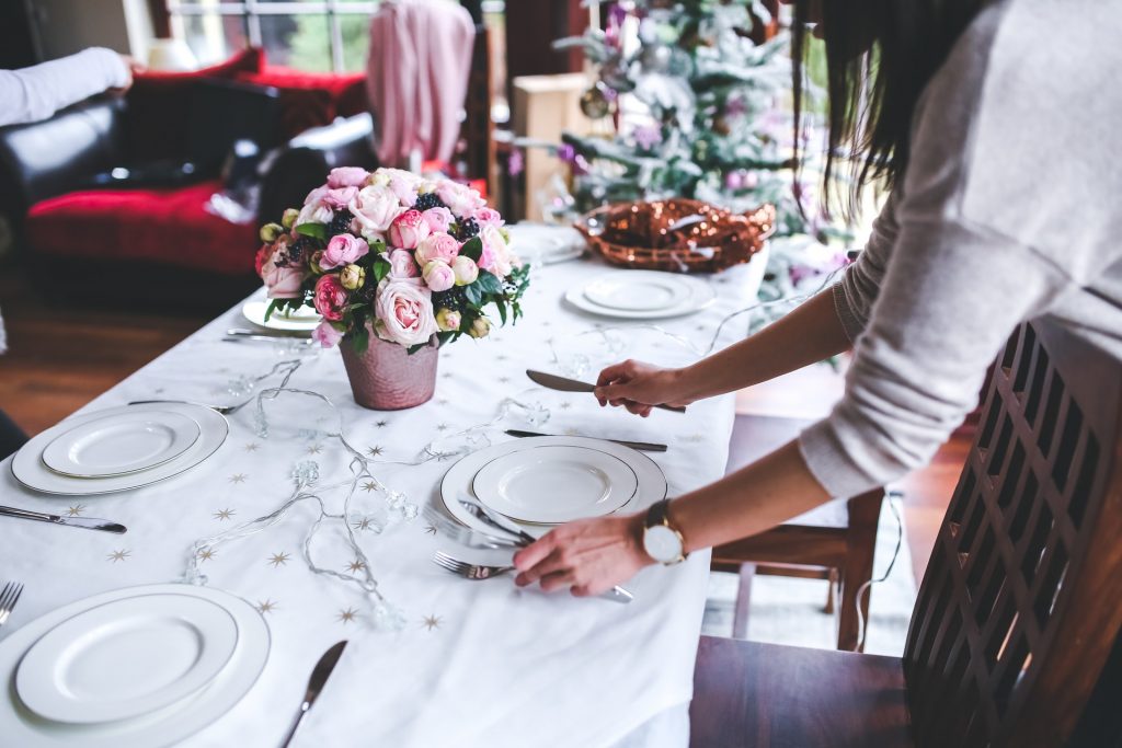 woman-flowers-holidays-girl-6270 table with dishes being set by woman