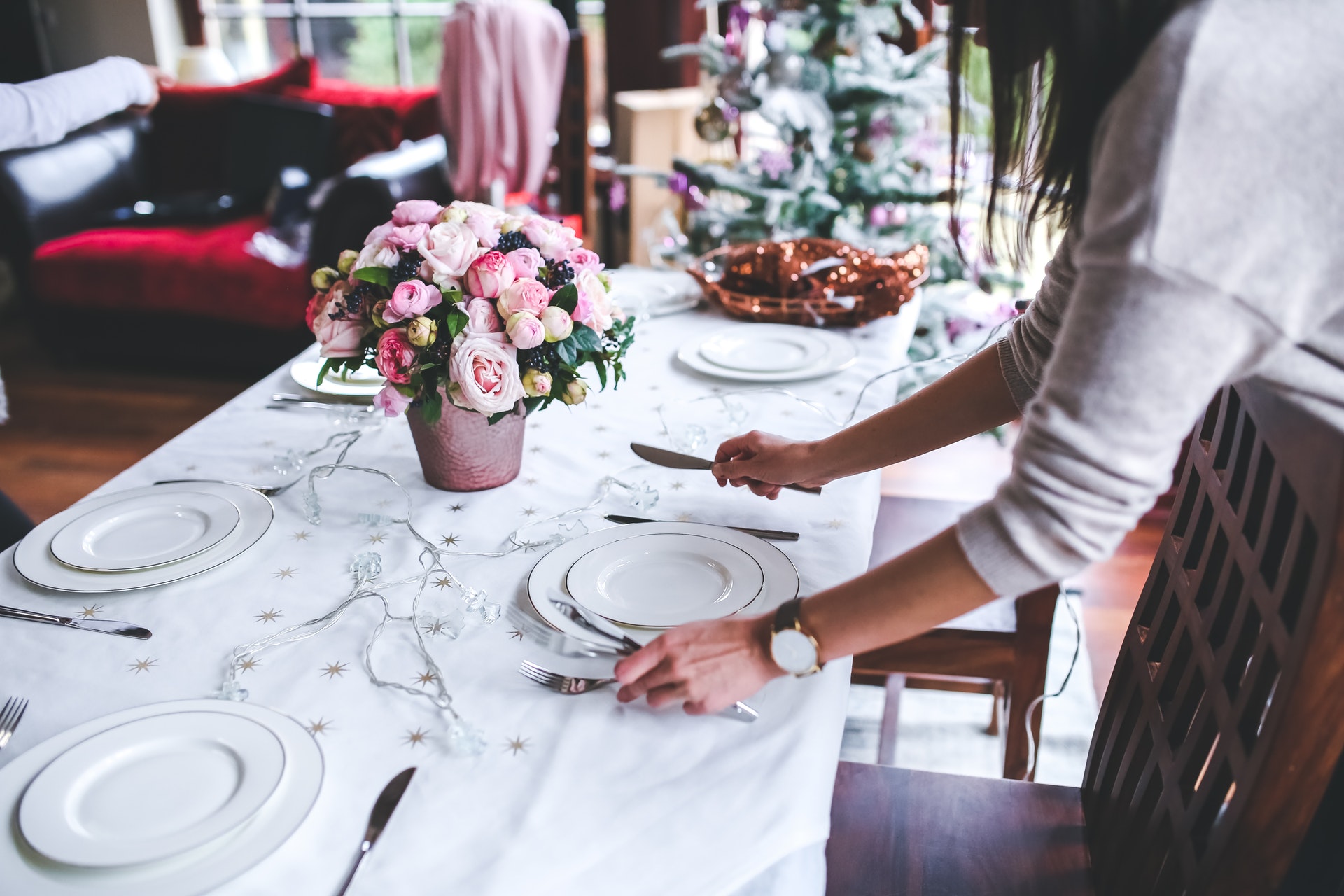 woman-flowers-holidays-girl-6270 table with dishes being set by woman
