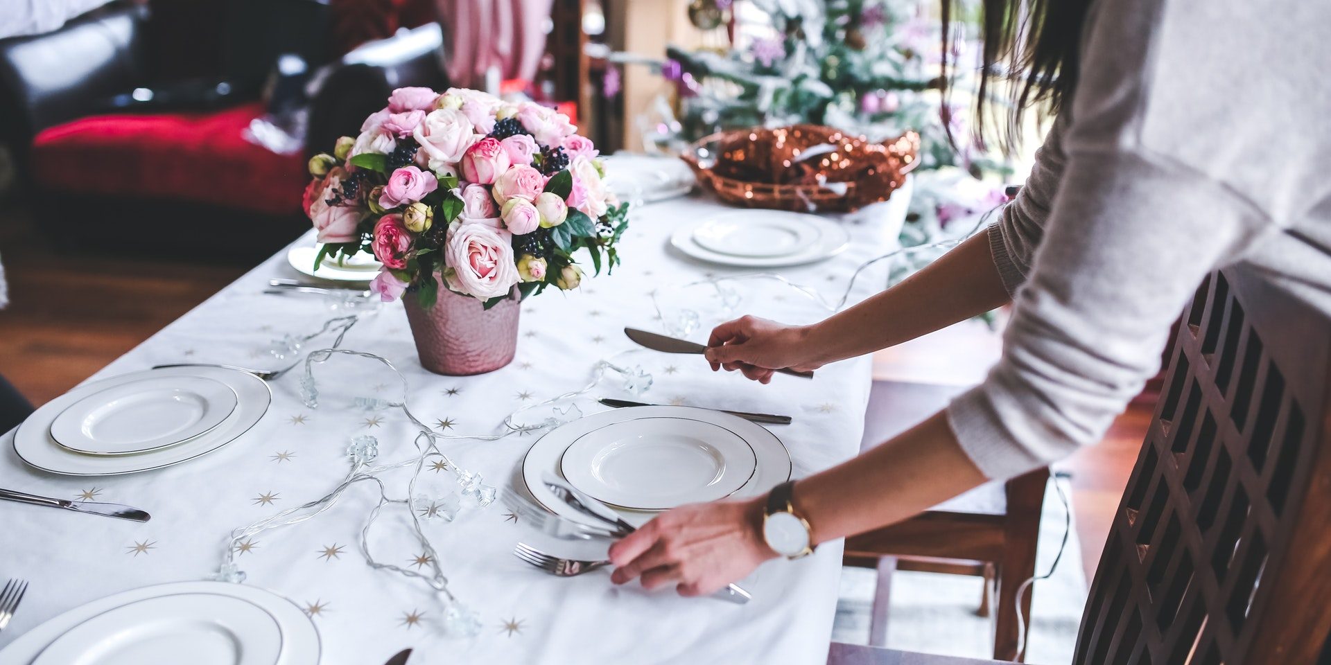 woman-flowers-holidays-girl-6270 table with dishes being set by woman